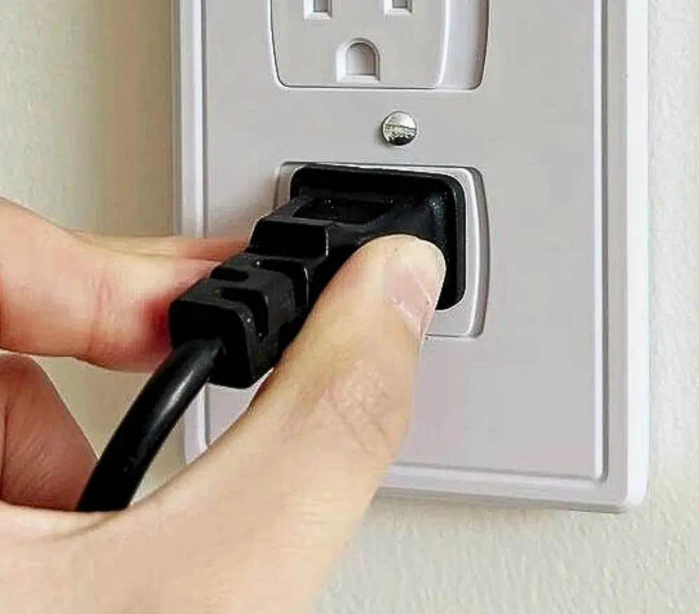 image of a person plugging a switch into a power strip
